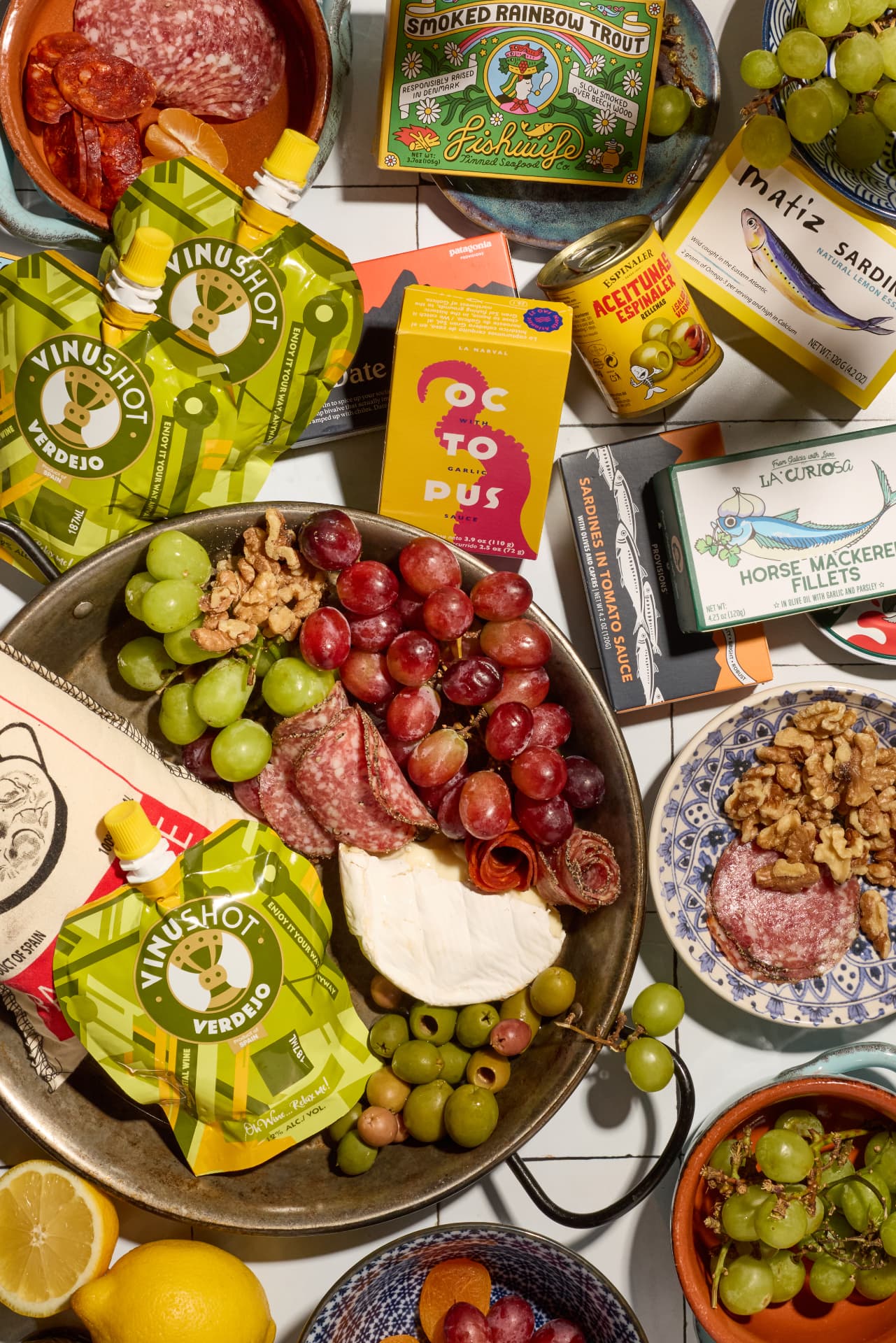 VinuShot pouches with a spread of food at home